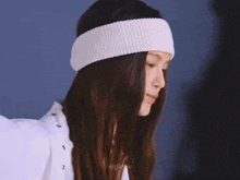 a woman wearing a white headband and a white shirt has the word nisfjanie written on the bottom
