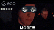 a man wearing a mask with euro symbols on his eyes is screaming with the words more below him