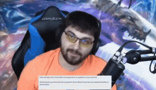 a man wearing glasses and headphones is sitting in front of a dxr racer gaming chair
