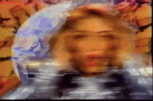 a blurry picture of a woman 's face with a blue circle in the middle
