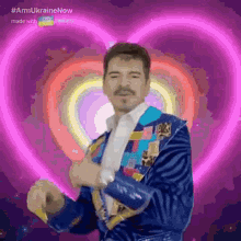 a man in a colorful suit is dancing in front of a heart .