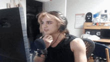 a man wearing headphones is sitting in front of a microphone