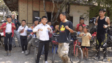 a man with a duck on his shirt is surrounded by children