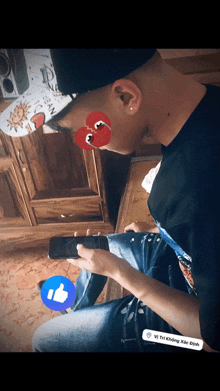 a man wearing a hat and sunglasses is playing a game on his cell phone