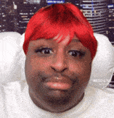 a man wearing a red wig and a white shirt with bigo live on the bottom right