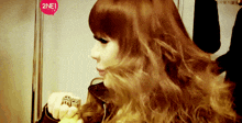 a woman with red hair has a 2ne1 logo on her head