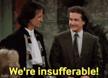 two men in suits are standing next to each other and saying we 're insufferable .