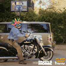 a man is riding an indian motorcycle in front of a basketball hoop