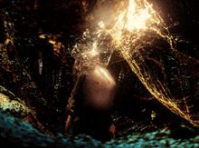 a person in a dark room with a light shining through