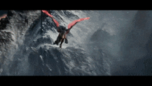 a dragon with red wings flies over a snowy mountain