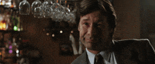 a man in a suit and tie with the words life 's a bitch below him