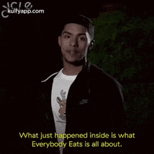 a man in a black jacket and white shirt is talking about what just happened inside is what everybody eats is all about .