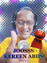 a man giving a thumbs up next to elmo and the name joosss