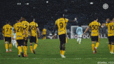 a group of soccer players wearing yellow uniforms with the number 9 on their back