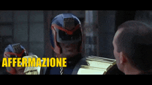 a man in a helmet is talking to another man with the words affermazione prevedibile written in yellow