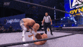 a wrestler is being pinned down by another wrestler in a ring with a sign that says lady 's place
