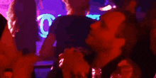 a blurry picture of people in a dark room with a red light behind them