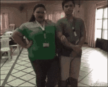a man and a woman standing next to each other in a room