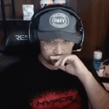 a man is wearing headphones and a hat that says obey