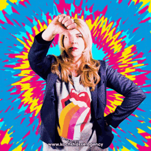 a woman wearing a rolling stones shirt is giving a thumbs down