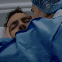 a man in a hospital bed with his eyes closed