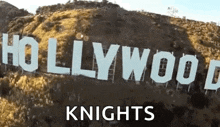 the hollywood sign is located on top of a hill .