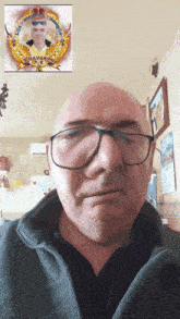 a man wearing glasses has a picture of a man with the name navarro above his head
