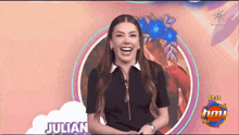 a woman is laughing in front of a sign that says julian on it