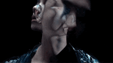 a close up of a person 's face in the dark