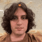 a man with curly hair has a sticker on his forehead that says ' netflix '