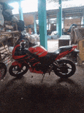 a red and black motorcycle is parked in a garage with pixverse.ai written on the bottom