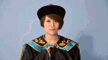 a woman in a costume with chinese characters on the bottom