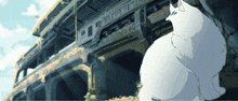 a white cat is sitting in front of a building that says ' tokyo ' on the side