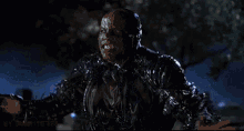 a close up of a person in a superhero costume with their arms outstretched .