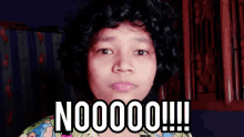 a woman with curly hair says nooooo !!! in front of her