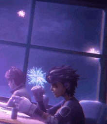 two people are sitting at a table watching fireworks in the sky
