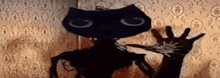 a silhouette of a black cat holding a hand in front of a wall with a pattern .