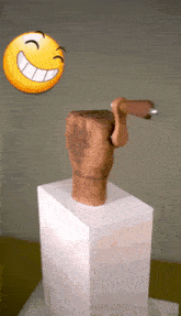 a statue of a hand with a smiley face on it