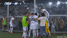 a group of soccer players are celebrating a goal against a team called gen