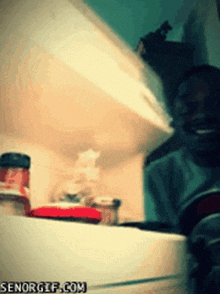 an open refrigerator with a bottle of ketchup on the bottom shelf and senorgif.com in the corner