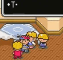 a group of people are standing in a room with a sign that says " t "