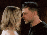 a man and a woman are looking at each other