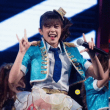 a girl in a blue and gold outfit is singing into a microphone