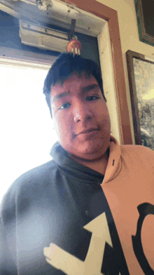 a man wearing a hoodie with the letter l on it