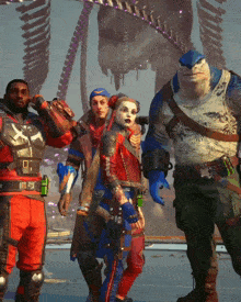 a group of people standing next to each other with one of them wearing a shirt that says ' suicide squad '