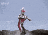 a man in a red and white suit is flying through the air with a purple light coming out of his hands .