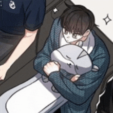 a man is holding a stuffed animal on a toilet