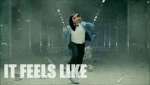 a man in a suit and tie is dancing with the words " it feels like " below him