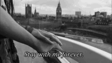 a black and white photo of a woman 's hand on a railing with the words stay with me forever .