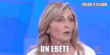 a woman is talking into a microphone and the words un ebete are on her face